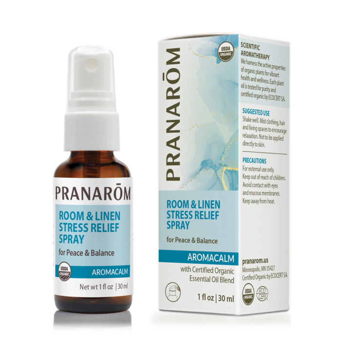 Pranarom Aromacalm Room and Linen Stress Relief Spray, in a 1 fl. oz. glass amber bottle with a chic blue and white label.